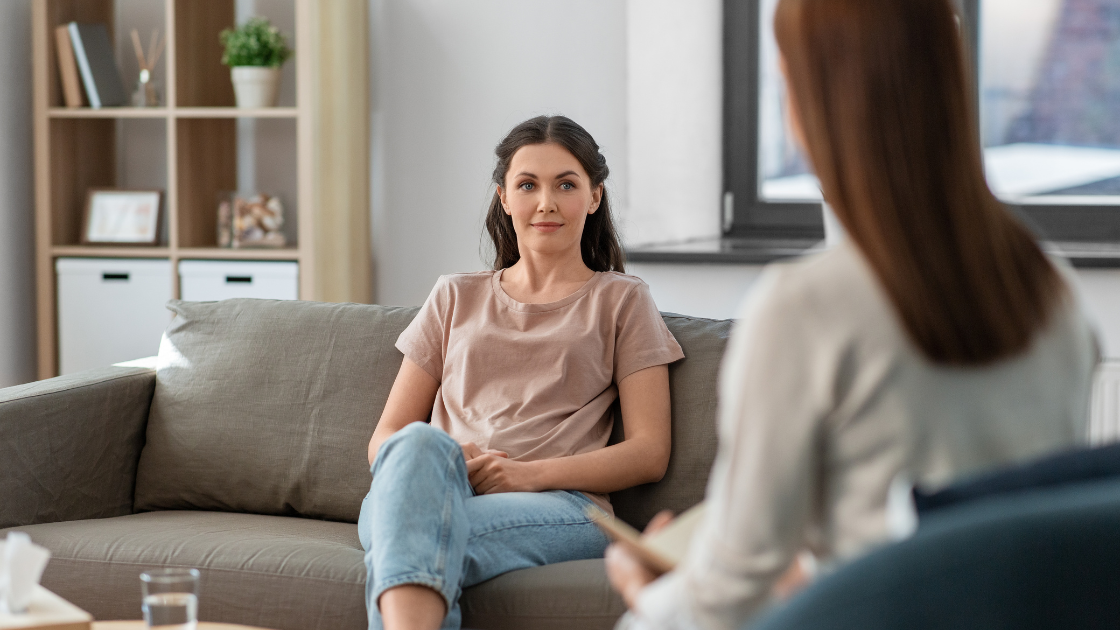 Woman looking content while sitting on a couch during a therapy session